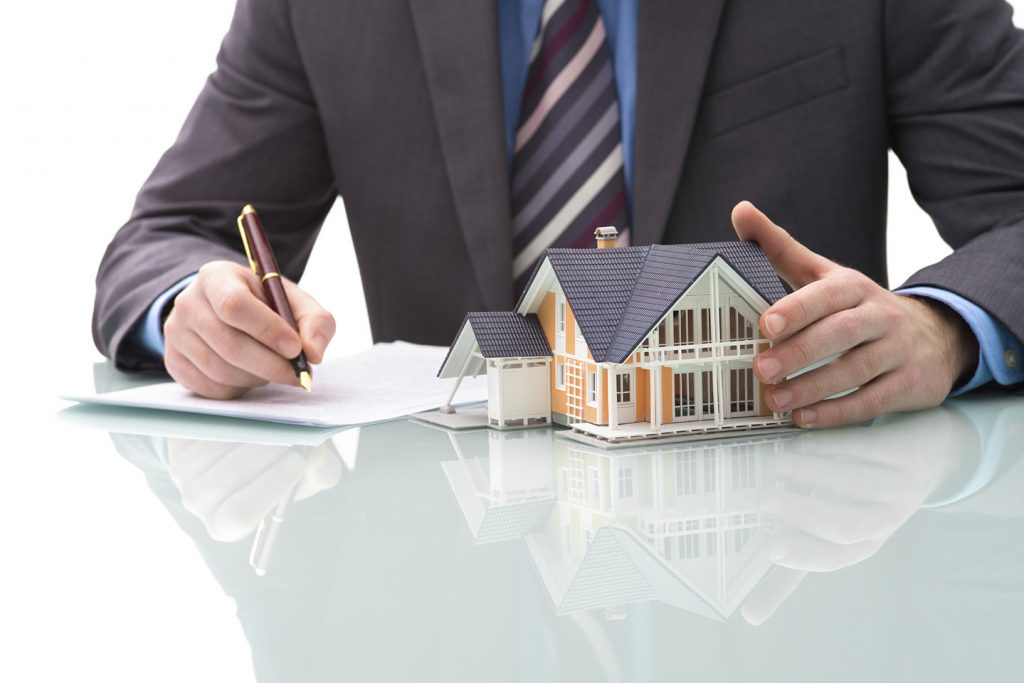 Man signs purchase agreement for a house
