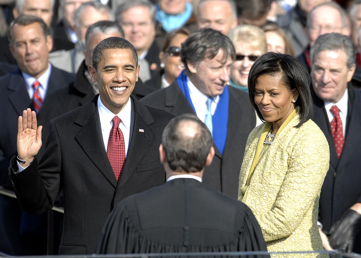 John Boehner, Barack Obama, Michelle Obama, Paul Pelosi standing next to a man in a suit and tie