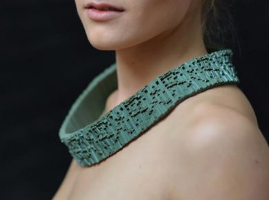 A close up of a person wearing a green shirt